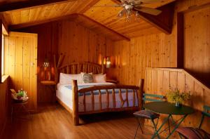 a bedroom with a bed and a ceiling fan at Ojai Rancho Inn in Ojai