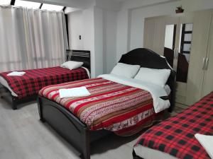Hostal Killaly Inn Cusco客房内的一张或多张床位