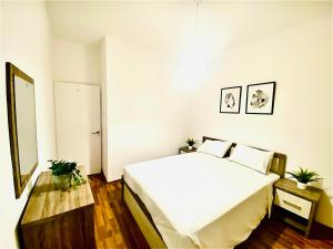 a bedroom with a large white bed in a room at CHADI APARTMENT in Larnaca