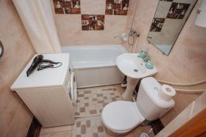 łazienka z toaletą, umywalką i wanną w obiekcie 1-комнатная квартира в центре на Аль-Фараби 93 w mieście Kustanaj