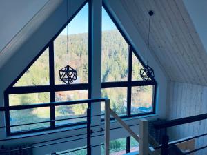 a room with a large window with a view at Apartament Na Szlaku in Sowa