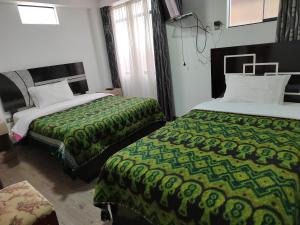 Hostal Killaly Inn Cusco客房内的一张或多张床位