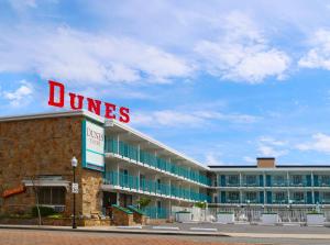 a dunes hotel with a sign on top of it at Dunes Court in Ocean City