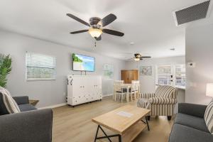 a living room with a ceiling fan and a table at Matlacha on Shoreview in Matlacha