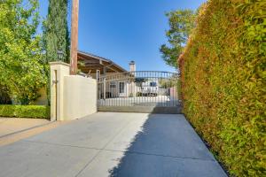 a sidewalk in front of a hedge in front of a house at Luxe Pasadena Casita with Fireplace and Grill in Pasadena