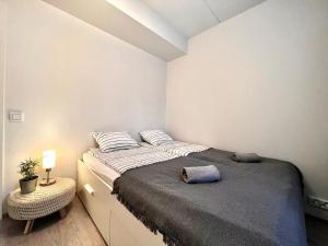 a bedroom with a large bed and a night stand at Easy Stay Room near Airport in Vantaa
