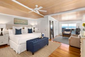 a bedroom with a bed and a ceiling fan at Inn on the Sound in Falmouth
