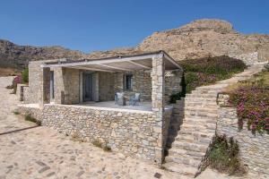 a stone house with a stone wall at Dreamy Cycladic Summer House 3 in Serifos Chora