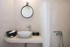 a bathroom with a sink and a mirror on the wall at Dreamy Cycladic Summer House 3 in Serifos Chora