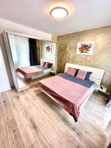 um quarto com uma cama e um espelho em Mega Rossa Residence em Bucareste