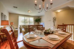 a dining room and living room with a table and chairs at Resort Townhome: Perfect Orlando Vacation Spot in Orlando