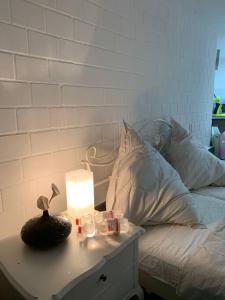 a bed with a table with a lamp on it at Villa Kunterbunt, W-Lan, Office in Leverkusen