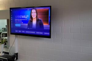 a flat screen tv hanging on a wall at Villa Kunterbunt, W-Lan, Office in Leverkusen