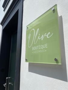 a sign on the side of a wine boutique storefront at Olive Boutique Guesthouse in Vila Franca do Campo