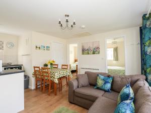a living room with a couch and a table at 14 The Dell in Norwich +17 photos