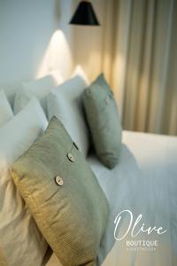 a white couch with pillows on top of it at Olive Boutique Guesthouse in Vila Franca do Campo