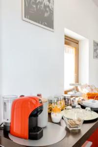 an orange toaster sitting on top of a kitchen counter at Oleandro Room in San Severino Lucano