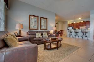 a living room with a couch and a table at Lakeview Executive Penthouse in Orlando