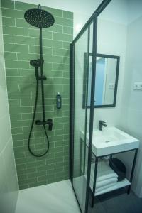 a bathroom with a shower and a sink at Olive Boutique Guesthouse in Vila Franca do Campo