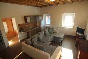 a living room with a couch and a kitchen at Apartment Ostružná in Ostružná