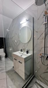 a bathroom with a sink and a mirror at PG Luxury Apartment in Kavala