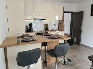 a kitchen with a table with chairs and wine glasses at Apartman Nika in Crikvenica