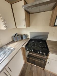 a kitchen with a stove top oven in a kitchen at 188 Holiday Resort Unity Brean - Central Location Pet Stays Free - Passes included in Brean