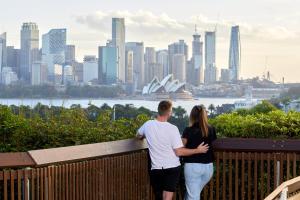 a man and a woman looking at a city skyline at Roar And Snore in Sydney