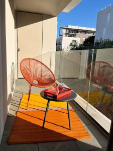 two chairs and a table on a balcony at Superbe Appart 2P pour 4 pers à 5 min TGV RER Orly in Massy +26 photos
