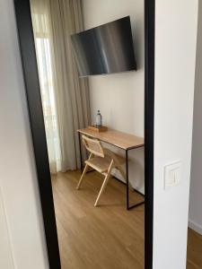 a table and chair in a room with a mirror at Olive Boutique Guesthouse in Vila Franca do Campo