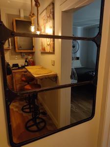 a mirror reflection of a kitchen with a table and a desk at B&B San Paolo Sweethome in Parma