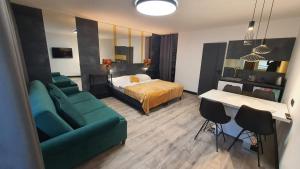 a hotel room with a bed and a couch and a table at Dom Gościnny Złota Rybka in Dziwnów