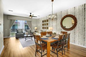 a dining room and living room with a table and chairs at Spacious Townhome wPatio Garage Sleeps10 in Orlando