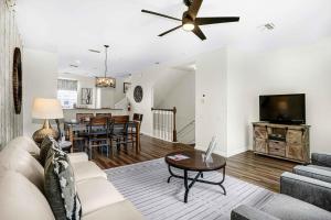 a living room with a couch and a tv and a table at Spacious Townhome wPatio Garage Sleeps10 in Orlando