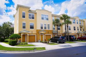 a building with a car parked in front of it at Spacious Townhome wPatio Garage Sleeps10 in Orlando