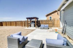 a patio with couches and a grill with a table at Cozy Colorado Retreat with Patio, Grill and Fire Pit! in Alamosa