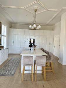 a kitchen with a table and chairs in a room at Room in exclusive villa in sentral Oslo in Oslo