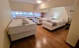 a bedroom with two beds and a table and a dining room at PG Luxury Apartment in Kavála