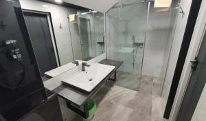 a bathroom with a sink and a shower at Dom Gościnny Złota Rybka in Dziwnów +47 photos