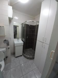 a bathroom with a shower and a toilet and a sink at Royal Classico Getaway in Strand Beach in Cape Town