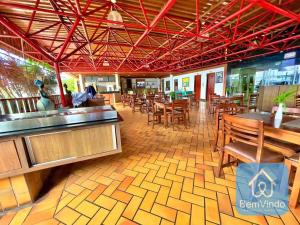 a dining room with tables and chairs and a restaurant at Apartamento completo com píer e acesso ao mar 4 in Salvador