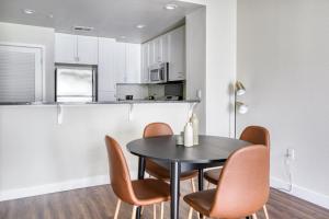 a dining room with a black table and chairs at Santa Clara 1BR w WD Gym SFO-835 in Santa Clara