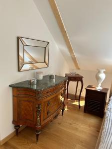 a room with a wooden dresser and a mirror at Leśna Residence & SPA in Pisz