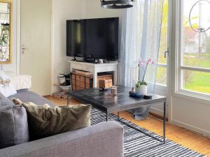 a living room with a couch and a tv at 4 person holiday home in Spekeröd-By Traum in Spekeröd