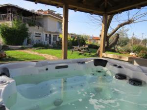 a hot tub in the backyard of a house at Dror Winery in Kefar Shammay