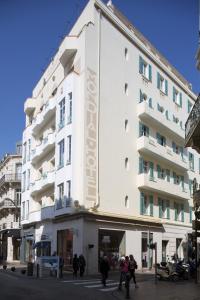 a white building with people walking in front of it at BW Premier Collection Mondial in Cannes