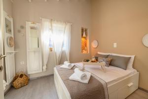 a bedroom with a large bed with towels on it at Casa Iolanda II in Corfu