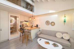a living room with a couch and a table at Casa Iolanda II in Corfu +9 photos