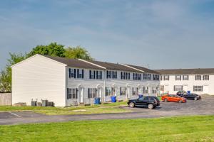 a large white building with cars parked in a parking lot at Bowling Green Vacation Rental Near WKU and Downtown! in Bowling Green