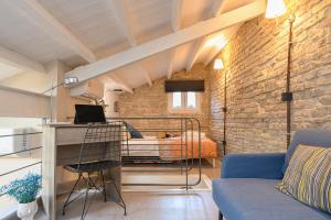 a room with a bed and a room with a couch at Casa Iolanda II in Corfu